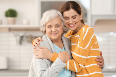 woman smiling together with the senior woman