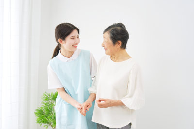 woman smiling at the senior woman