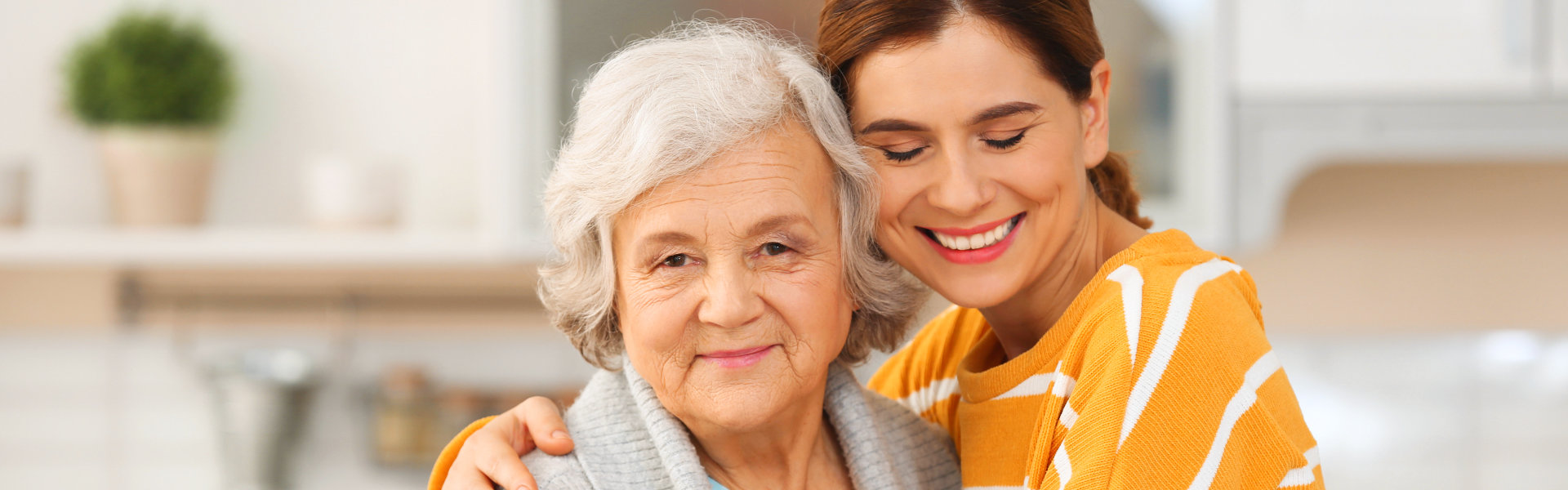 woman smiling together with the senior woman