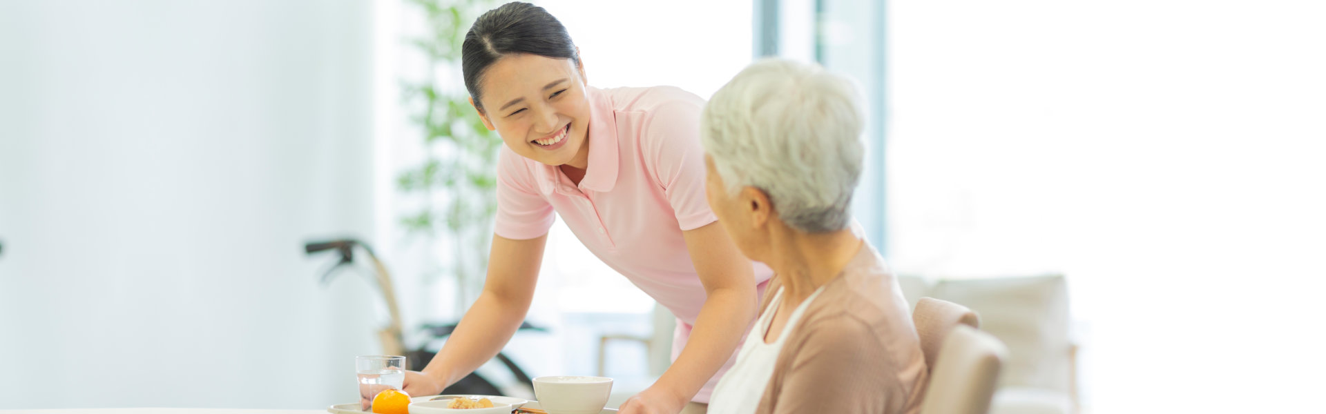 woman smiling at the senior woman