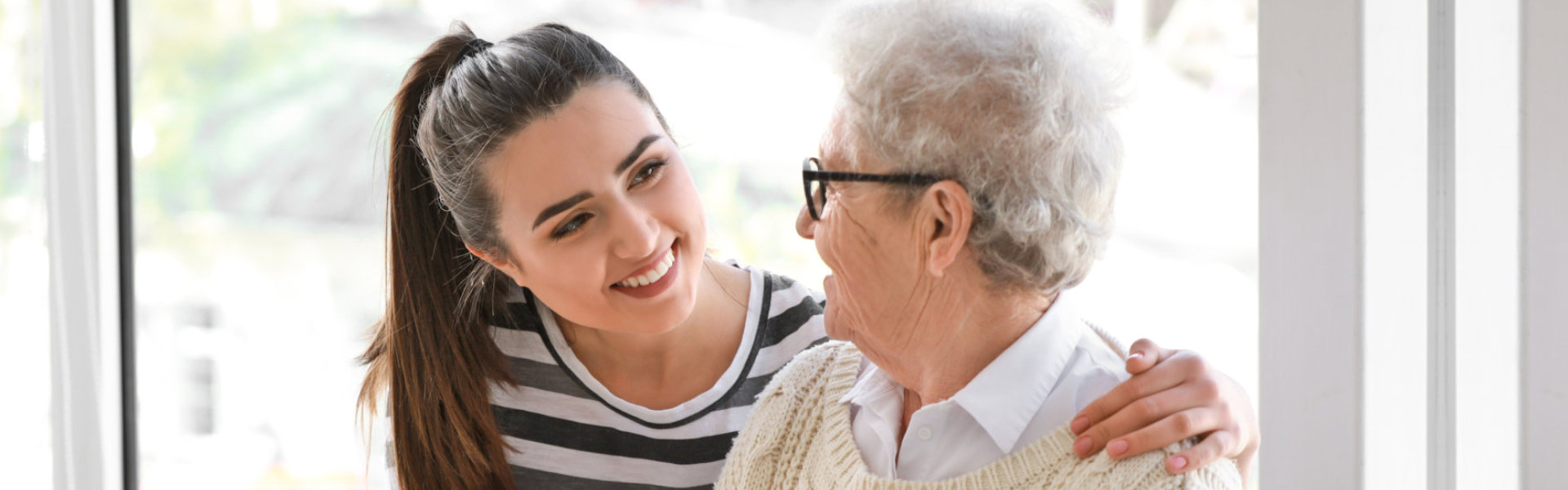 woman and senior man smiling at each other